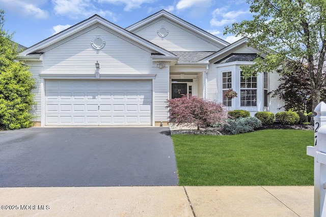 27 Cromwell Ln, Jackson, NJ 08527 - view of front facade featuring driveway, an attached garage, and a front lawn