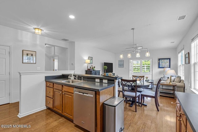 27 Cromwell Ln, Jackson, NJ 08527 - kitchen with stainless steel dishwasher, open floor plan, a sink, brown cabinets, and light wood-style flooring