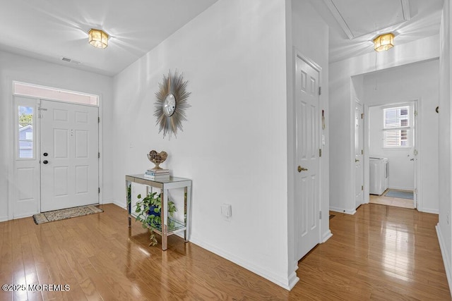 27 Cromwell Ln, Jackson, NJ 08527 - foyer entrance featuring washing machine and dryer, wood finished floors, and baseboards