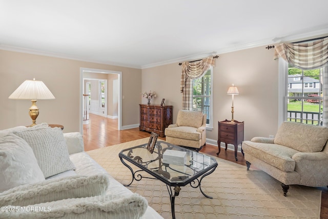 10 Woods Rd, West Long Branch, NJ 07764 - living room with healthy amount of natural light, ornamental molding, wood finished floors, and baseboards