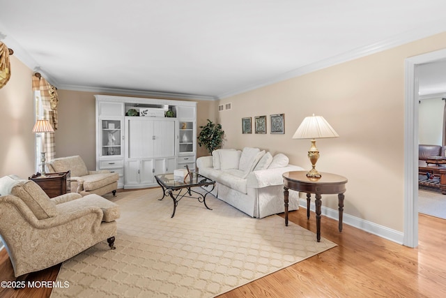 10 Woods Rd, West Long Branch, NJ 07764 - living room featuring light wood-type flooring, ornamental molding, and baseboards