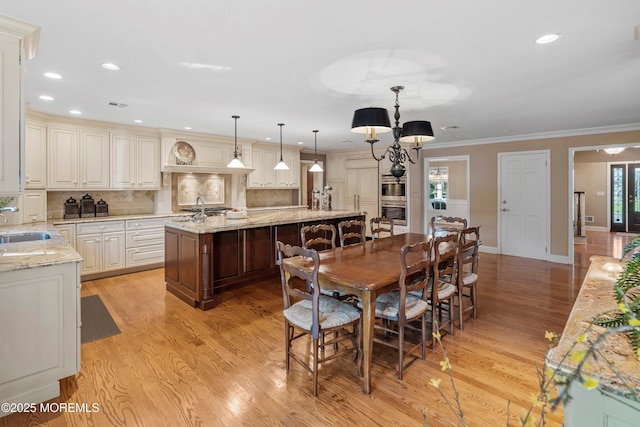 10 Woods Rd, West Long Branch, NJ 07764 - dining room featuring light wood-style floors, recessed lighting, baseboards, crown molding, and a chandelier