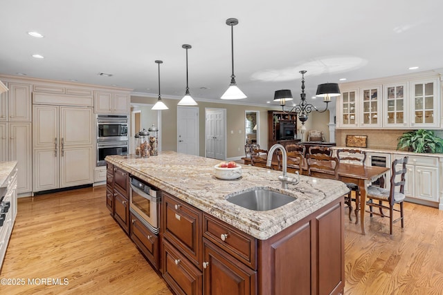 10 Woods Rd, West Long Branch, NJ 07764 - kitchen with a sink, a center island with sink, wine cooler, built in appliances, and light wood finished floors