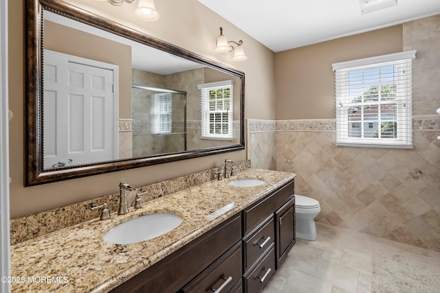10 Woods Rd, West Long Branch, NJ 07764 - full bathroom featuring a shower stall, healthy amount of natural light, double vanity, tile walls, and toilet