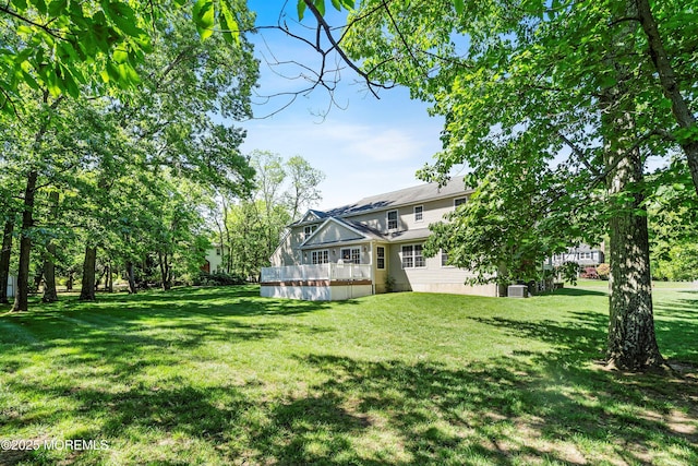 10 Woods Rd, West Long Branch, NJ 07764 - view of green lawn with a wooden deck and central air condition unit