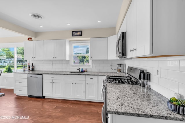 8 Brakenbury Ct, Toms River, NJ 08757 - kitchen featuring stainless steel appliances, a sink, light stone countertops, backsplash, and white cabinets