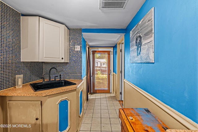 12 Central Ave, Waretown, NJ 08758 - kitchen featuring a sink, light tile patterned floors, white cabinetry, and light countertops
