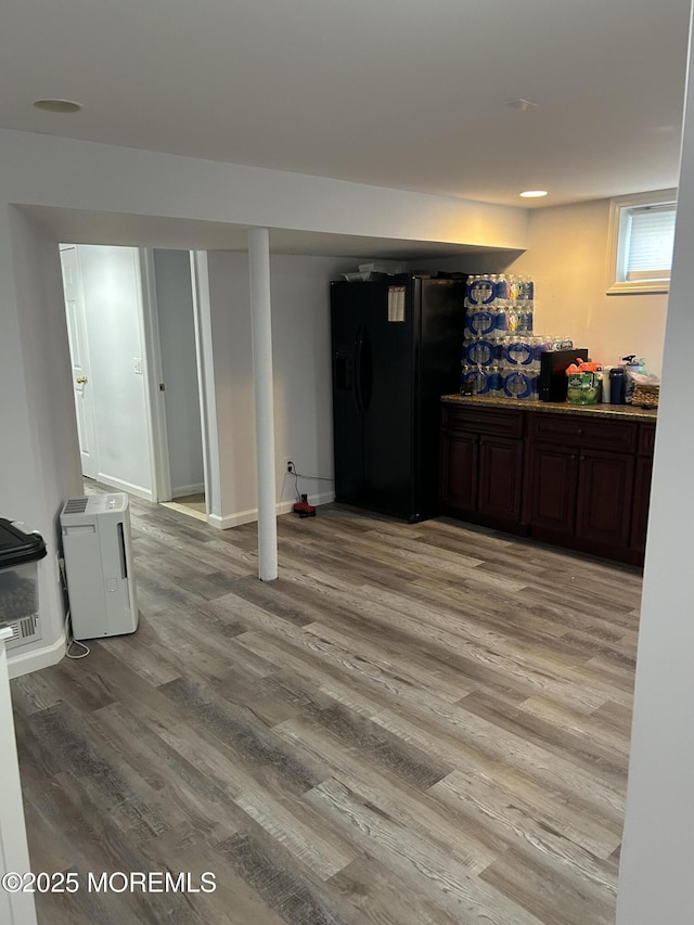 11 Jupiter Ct, South Amboy, NJ 08879 - below grade area featuring black fridge, light wood-style flooring, and baseboards