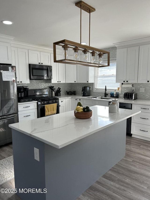 11 Jupiter Ct, South Amboy, NJ 08879 - kitchen with appliances with stainless steel finishes, white cabinetry, decorative backsplash, a center island, and recessed lighting