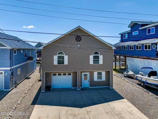 43 S Ensign Dr, Little Egg Harbor, NJ 08087 - view of front facade with driveway, an attached garage, and cooling unit