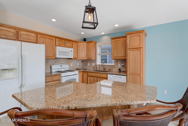 43 S Ensign Dr, Little Egg Harbor, NJ 08087 - kitchen with white appliances, a sink, a breakfast bar, decorative backsplash, and light stone countertops