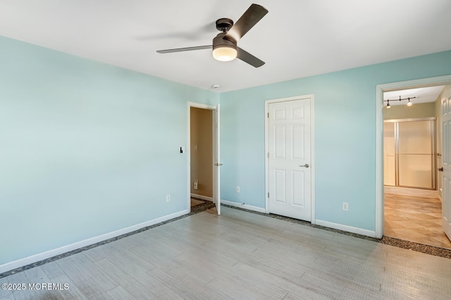 43 S Ensign Dr, Little Egg Harbor, NJ 08087 - unfurnished bedroom featuring baseboards, ensuite bathroom, a ceiling fan, rail lighting, and light wood-type flooring