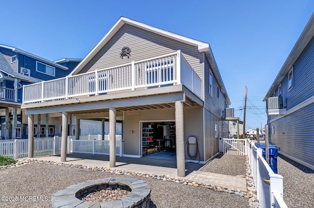 43 S Ensign Dr, Little Egg Harbor, NJ 08087 - rear view of property featuring a fire pit, a patio, a deck, and central AC