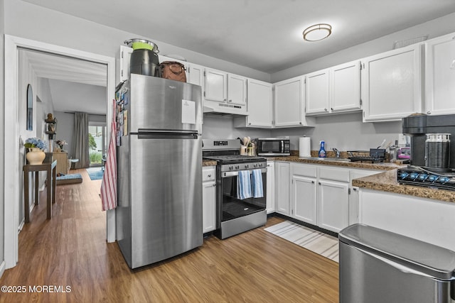 8 Fern Ct, Tinton Falls, NJ 07724 - kitchen featuring appliances with stainless steel finishes, under cabinet range hood, wood finished floors, and white cabinetry