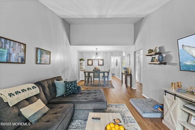8 Fern Ct, Tinton Falls, NJ 07724 - living room with a chandelier, wood finished floors, and a high ceiling