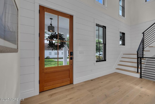 2110 Edgewood Pl, Spring Lake, NJ 07762 - entryway with plenty of natural light, stairway, wood-type flooring, and wood walls