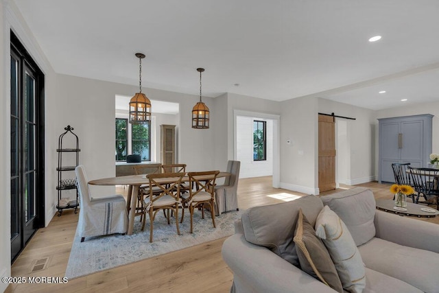2110 Edgewood Pl, Spring Lake, NJ 07762 - dining area with a barn door, light wood-style floors, recessed lighting, and baseboards