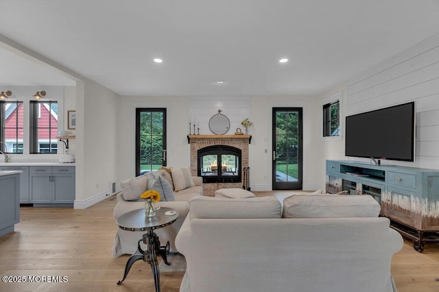 2110 Edgewood Pl, Spring Lake, NJ 07762 - living room with a brick fireplace, healthy amount of natural light, light wood-style floors, recessed lighting, and baseboards