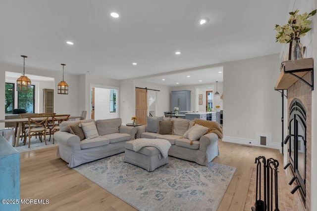 2110 Edgewood Pl, Spring Lake, NJ 07762 - living area with a barn door, light wood-style flooring, healthy amount of natural light, and recessed lighting