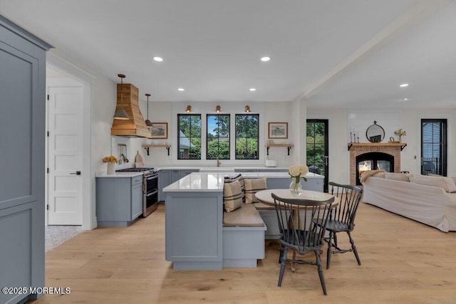 2110 Edgewood Pl, Spring Lake, NJ 07762 - kitchen featuring double oven range, custom range hood, gray cabinetry, light countertops, and light wood-style floors