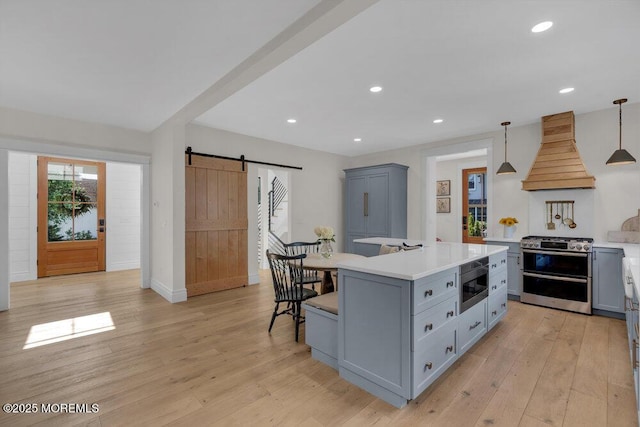 2110 Edgewood Pl, Spring Lake, NJ 07762 - kitchen with stainless steel appliances, custom exhaust hood, a barn door, gray cabinets, and recessed lighting