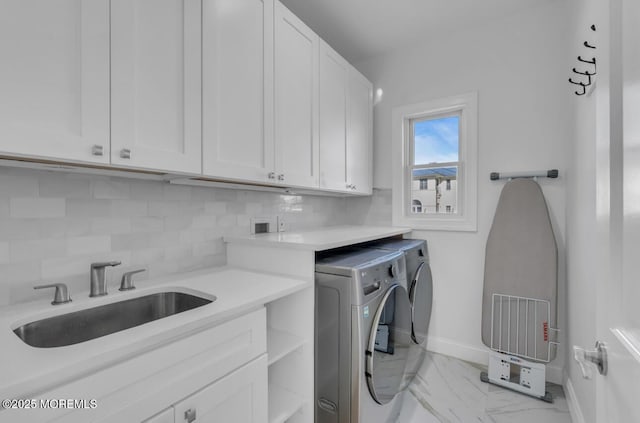 1 Private Dr, Elberon, NJ 07740 - laundry area featuring cabinet space, washer and dryer, baseboards, and light marble finish floors