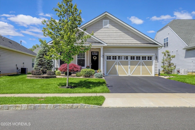 24 Moonlight Way, Howell, NJ 07731 - craftsman inspired home with an attached garage, asphalt driveway, a front lawn, and central AC