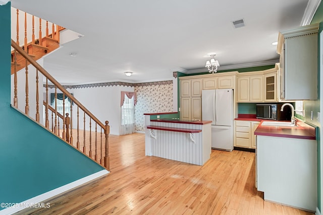 146 Inskip Ave, Ocean Grove, NJ 07756 - kitchen with freestanding refrigerator, crown molding, a sink, light wood-type flooring, and cream cabinets
