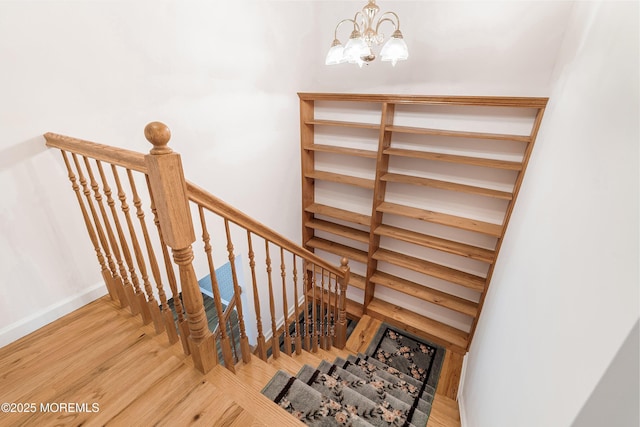 146 Inskip Ave, Ocean Grove, NJ 07756 - stairway with a chandelier, wood finished floors, and baseboards