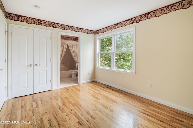 146 Inskip Ave, Ocean Grove, NJ 07756 - unfurnished bedroom featuring baseboards, wood finished floors, a closet, and connected bathroom
