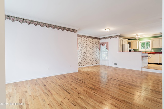 146 Inskip Ave, Ocean Grove, NJ 07756 - unfurnished living room with a chandelier, light wood finished floors, ornamental molding, a sink, and baseboards
