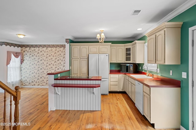 146 Inskip Ave, Ocean Grove, NJ 07756 - kitchen with black appliances, a sink, cream cabinetry, light wood-style flooring, and crown molding