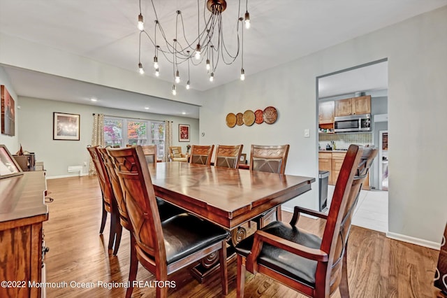 66 Cold Indian Springs Rd, Ocean Twp, NJ 07712 - dining room featuring light wood-style flooring, a chandelier, and baseboards