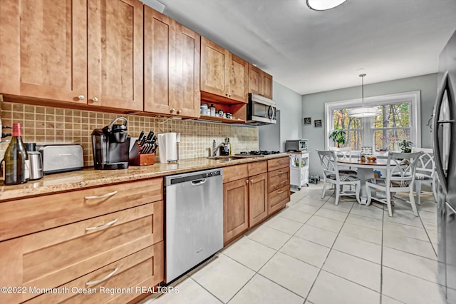 66 Cold Indian Springs Rd, Ocean Twp, NJ 07712 - kitchen with stainless steel appliances, tasteful backsplash, light tile patterned flooring, light stone counters, and a sink