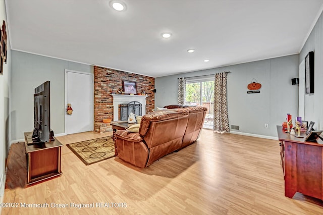 66 Cold Indian Springs Rd, Ocean Twp, NJ 07712 - living room featuring light wood-style floors, baseboards, a brick fireplace, recessed lighting, and ornamental molding