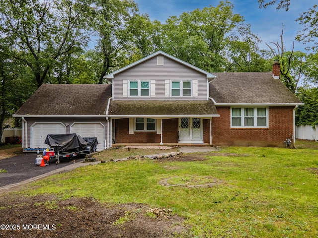 66 Cold Indian Springs Rd, Ocean Twp, NJ 07712 - view of front facade featuring an attached garage, a chimney, brick siding, and covered porch