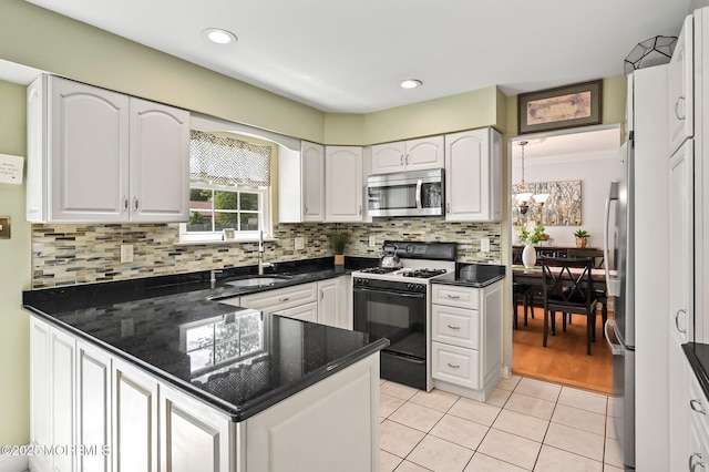15 Peachstone Rd, Howell, NJ 07731 - kitchen with appliances with stainless steel finishes, a chandelier, light tile patterned floors, a sink, and a peninsula