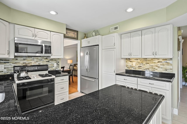 15 Peachstone Rd, Howell, NJ 07731 - kitchen featuring stainless steel appliances, light tile patterned floors, dark stone counters, white cabinetry, and recessed lighting
