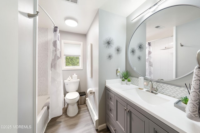 9 Crossridge Cir, Marlboro, NJ 07746 - full bathroom with a baseboard heating unit, toilet, wood finished floors, vanity, and shower / bath combo