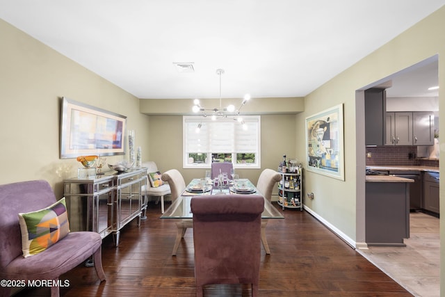 9 Crossridge Cir, Marlboro, NJ 07746 - dining space with a chandelier, wood finished floors, and baseboards