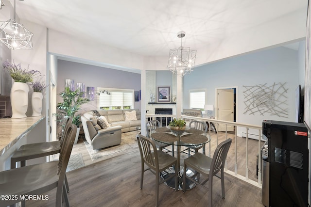 9 Crossridge Cir, Marlboro, NJ 07746 - dining space with a chandelier, wood finished floors, and a brick fireplace