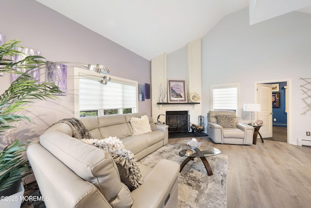 9 Crossridge Cir, Marlboro, NJ 07746 - living room featuring high vaulted ceiling, wood finished floors, plenty of natural light, a fireplace, and baseboards