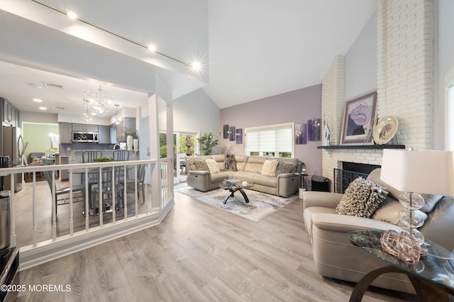 9 Crossridge Cir, Marlboro, NJ 07746 - living area featuring a fireplace, high vaulted ceiling, light wood-type flooring, and a chandelier