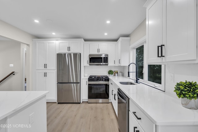 1117 Wake Forest Dr, Toms River, NJ 08753 - kitchen with stainless steel appliances, a sink, light wood-style flooring, white cabinets, and recessed lighting