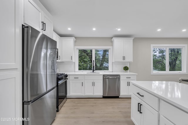 1117 Wake Forest Dr, Toms River, NJ 08753 - kitchen featuring stainless steel appliances, light countertops, recessed lighting, light wood-type flooring, and white cabinets