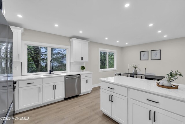 1117 Wake Forest Dr, Toms River, NJ 08753 - kitchen featuring stainless steel dishwasher, a sink, recessed lighting, light wood-style flooring, and white cabinetry