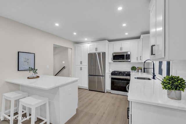 1117 Wake Forest Dr, Toms River, NJ 08753 - kitchen featuring appliances with stainless steel finishes, a sink, light stone countertops, white cabinets, and recessed lighting
