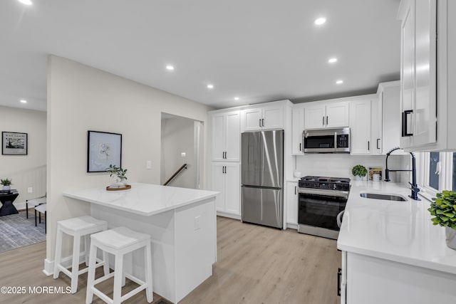 1117 Wake Forest Dr, Toms River, NJ 08753 - kitchen with appliances with stainless steel finishes, a sink, light stone counters, light wood-style flooring, and recessed lighting