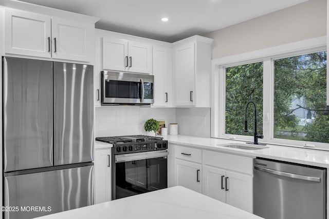 1117 Wake Forest Dr, Toms River, NJ 08753 - kitchen featuring appliances with stainless steel finishes, backsplash, a sink, white cabinetry, and recessed lighting