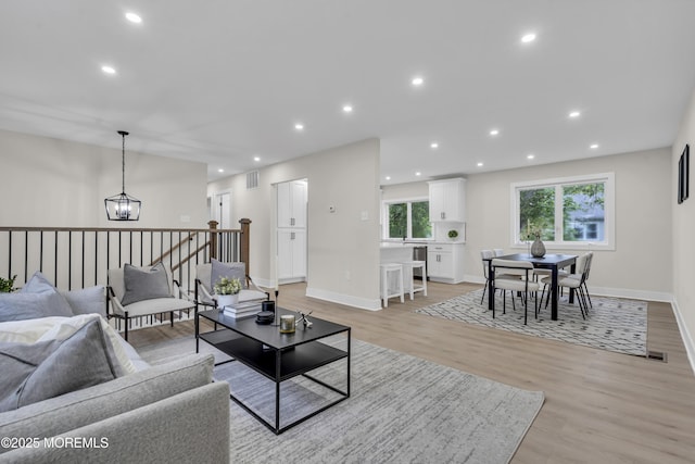 1117 Wake Forest Dr, Toms River, NJ 08753 - living room with light wood finished floors, a chandelier, baseboards, and recessed lighting